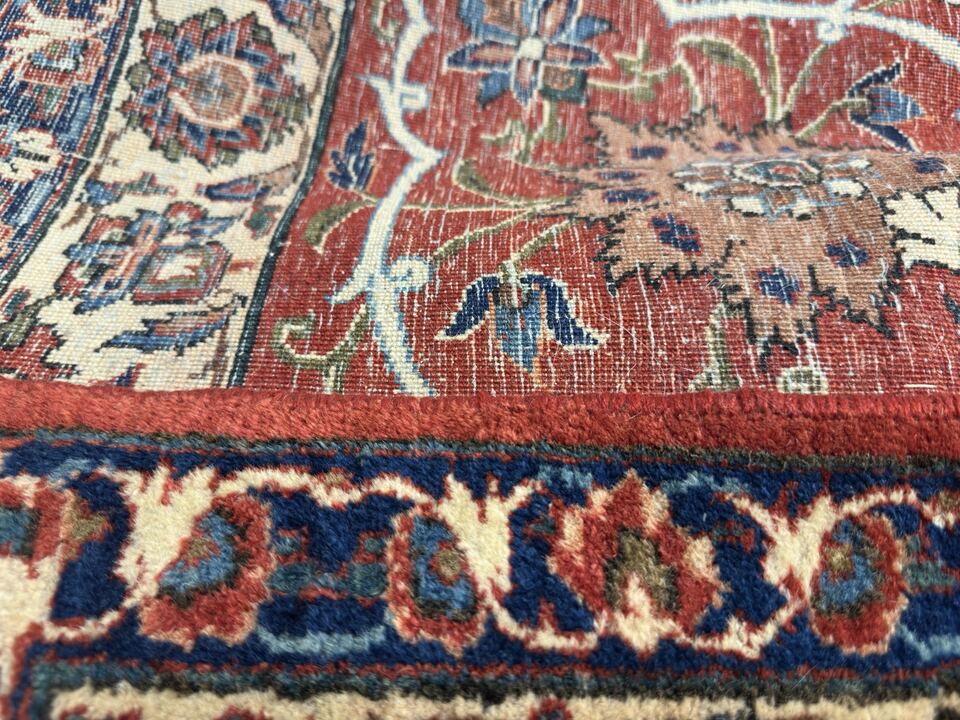 After binding repair: the same edge rewrapped by hand with matched red wool