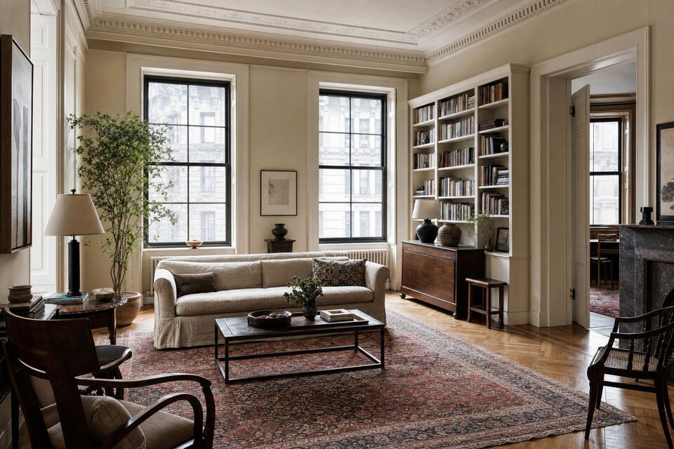 Prewar New York apartment living room with an antique Persian rug on herringbone parquet